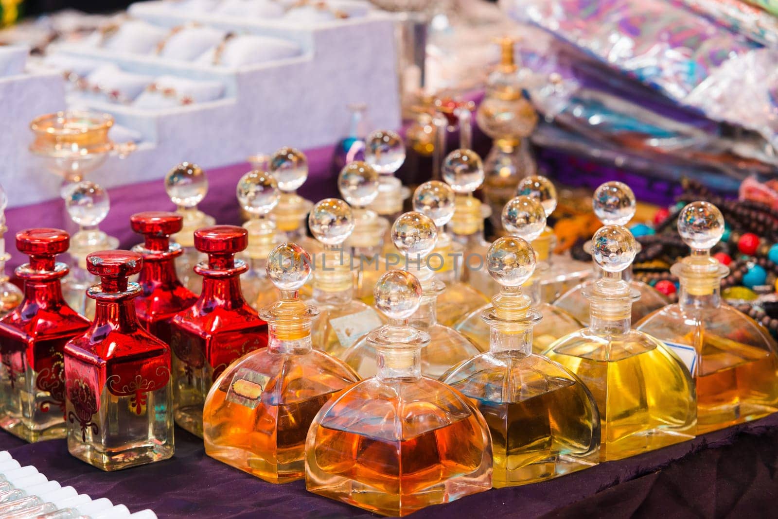 Arabian perfumes in  bottles at market. oil and rose flowers aromatherapy spa perfumery.
