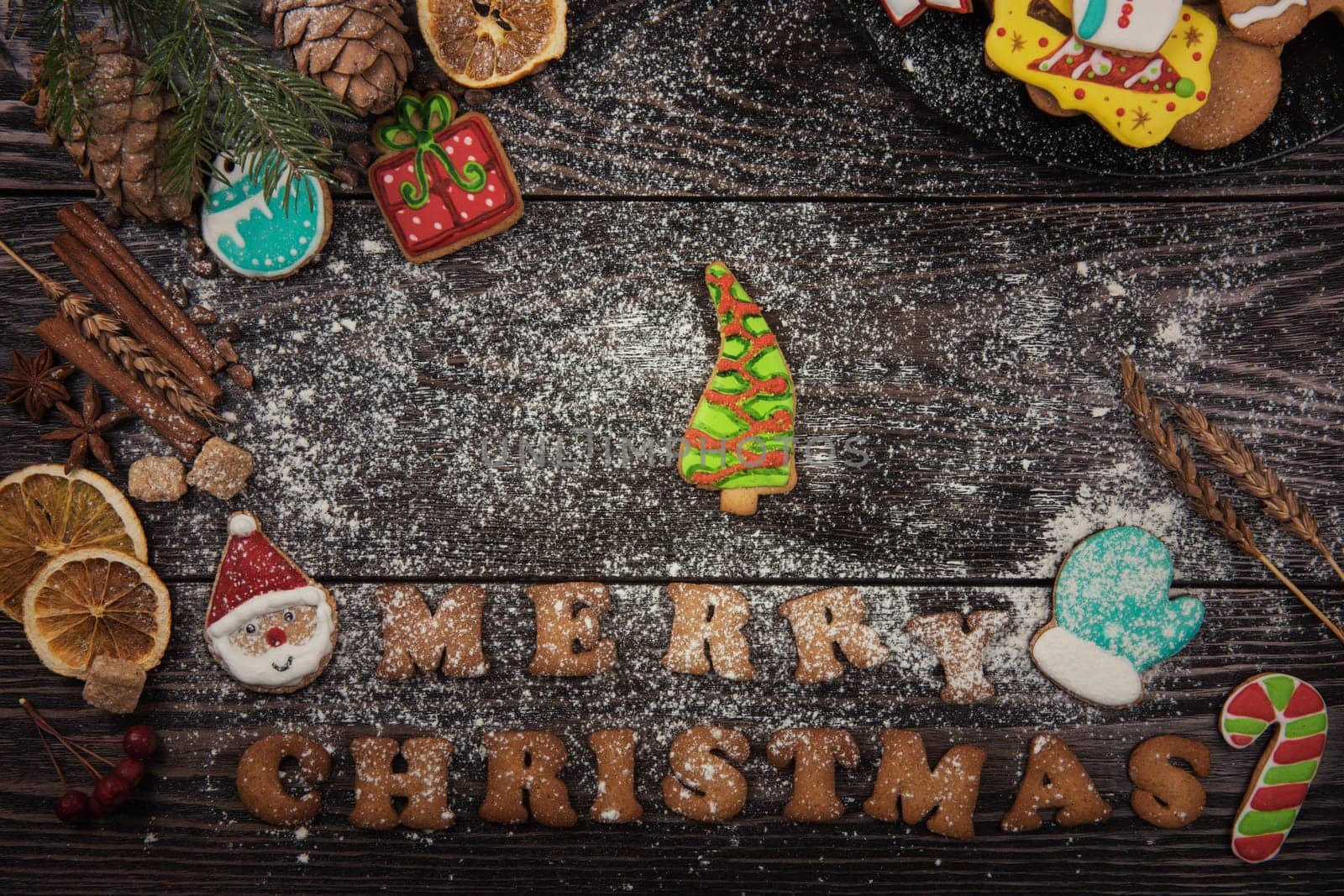 Gingerbreads for new years and christmas on wooden background with space for design