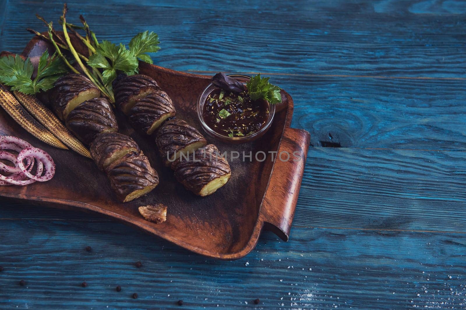 Grilled potato on a blue wooden background