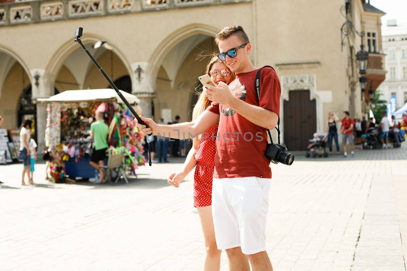 Krakow, Poland - July 29, 2017 : Tourist taking photos with his smartphone in historiccal center of city
