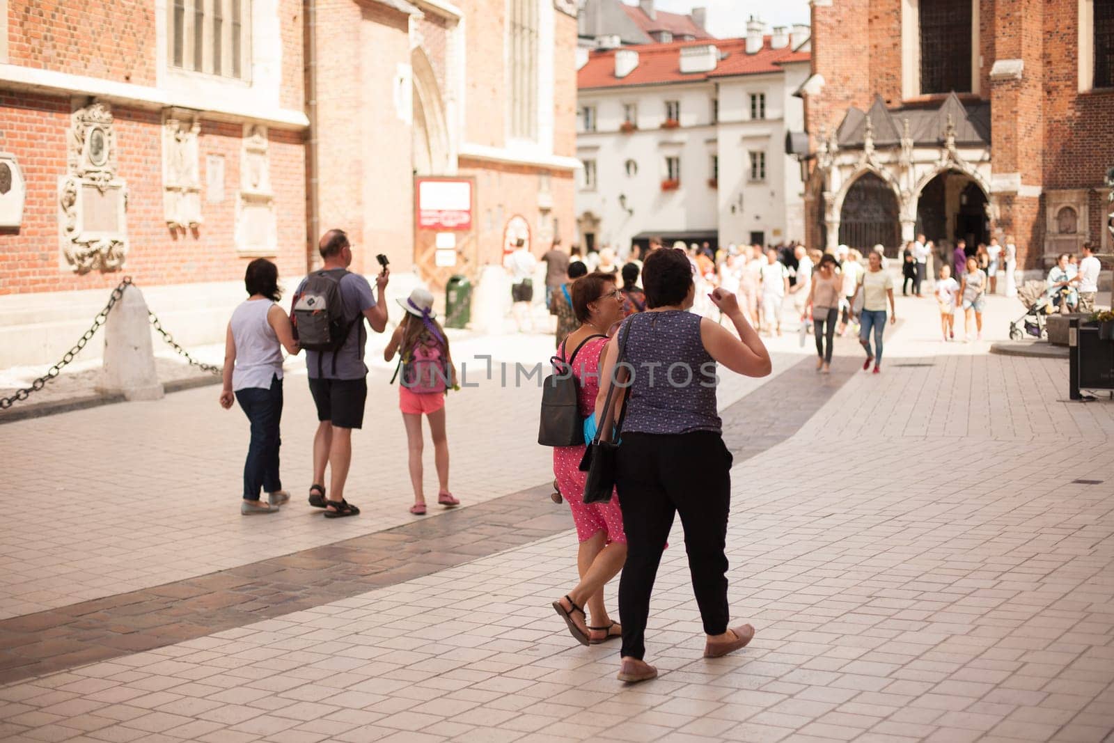 Krakow, Poland - July 29, 2017 : Tourist taking photos with his smartphone in historical center of city