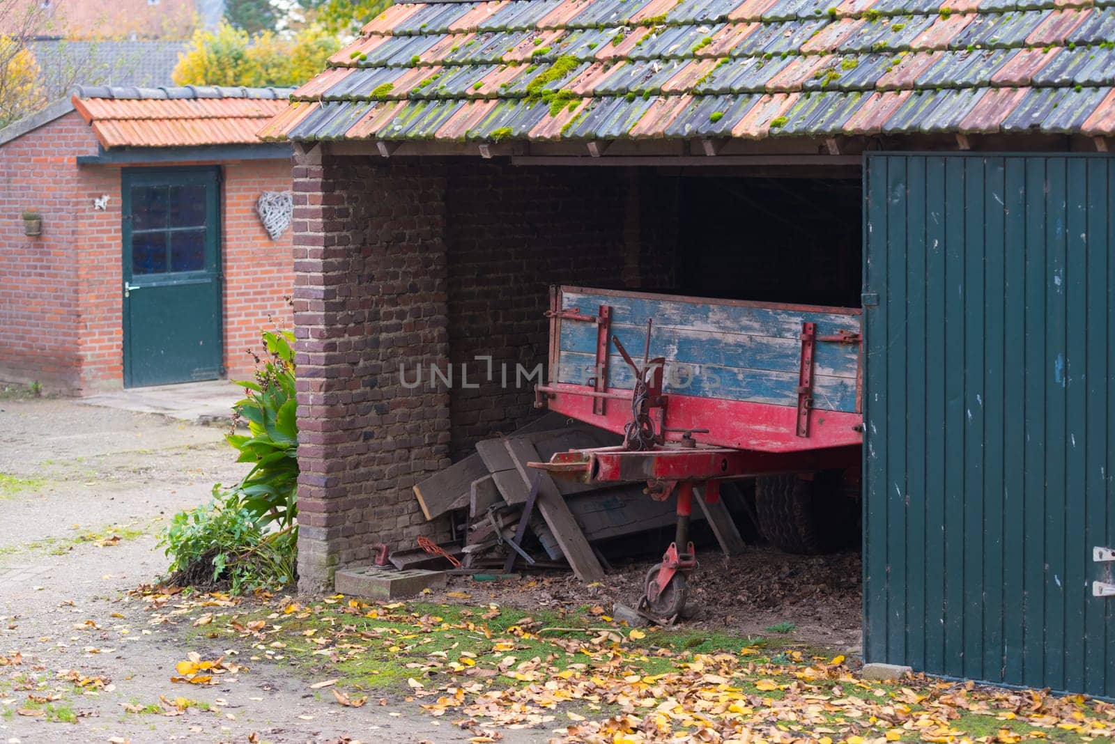 barn with agricultural vehicle in a small village