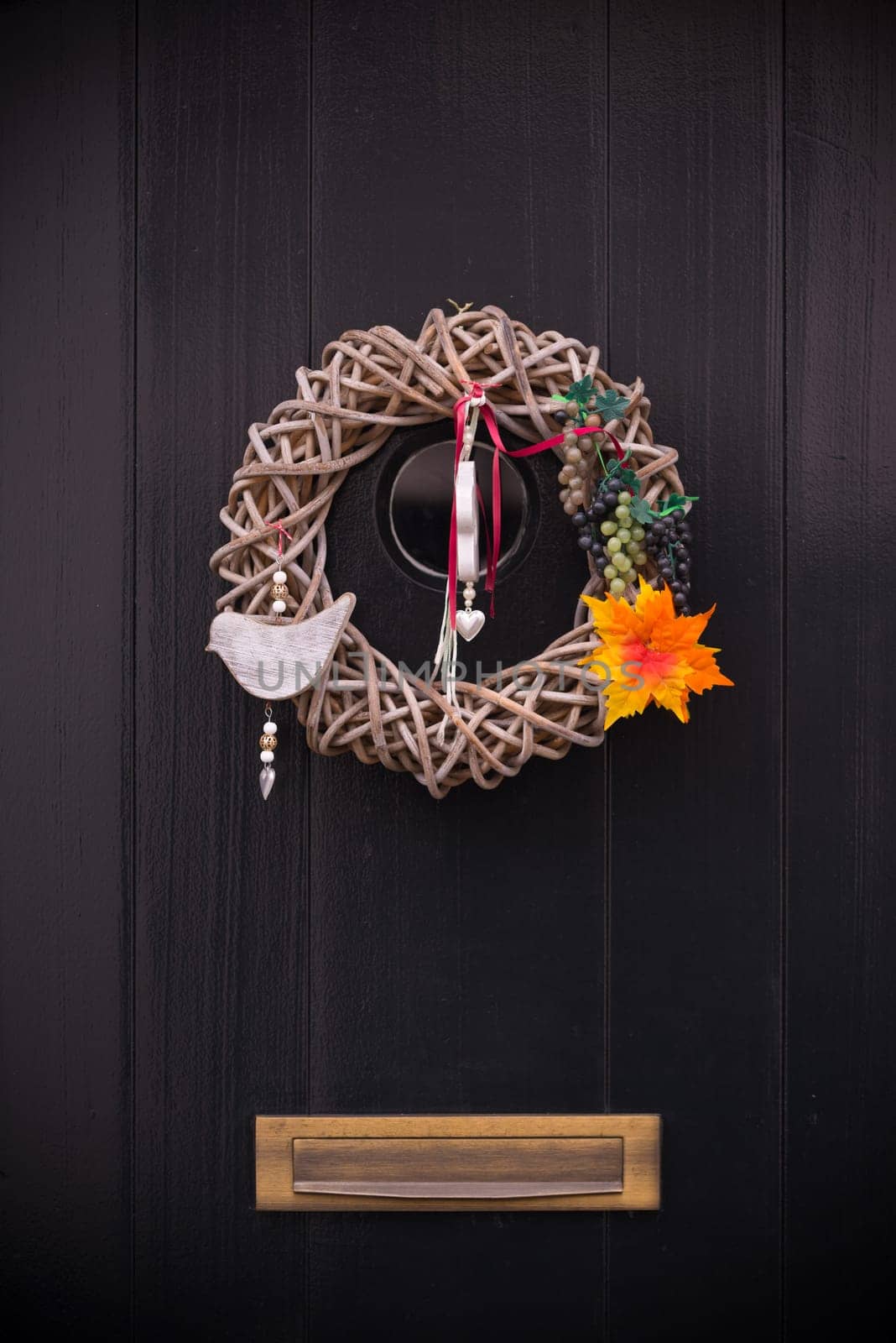 creative door decoration on a dark wooden door with mailbox