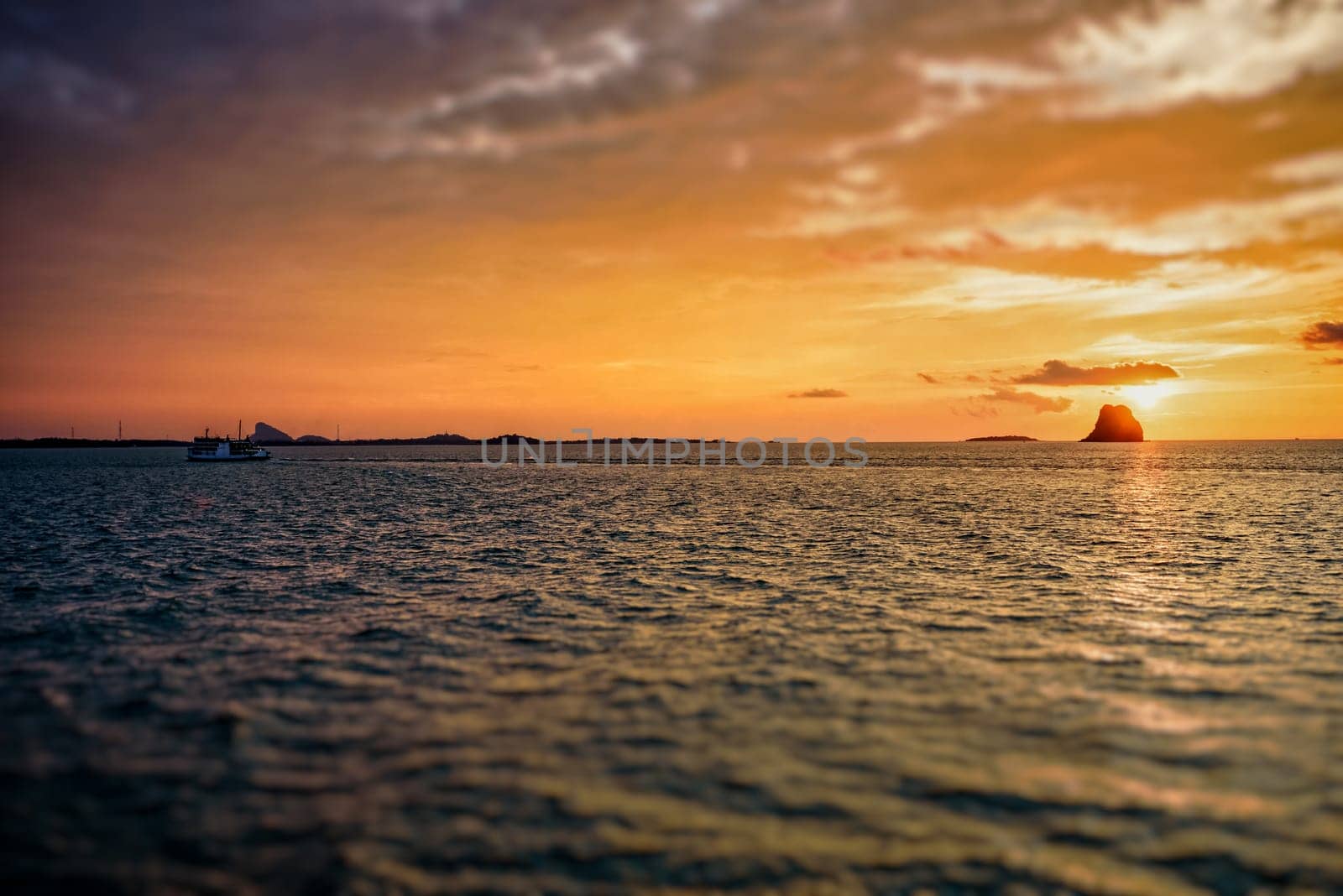 Beautiful natural landscape of colorful cloud sky and sun at sunset over the sea in Surat Thani province, Thailand
