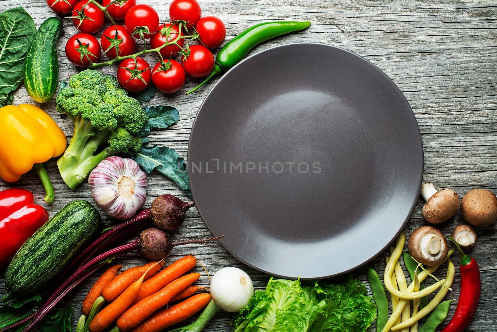 Various fresh vegetables and ingredients on wooden rustic background