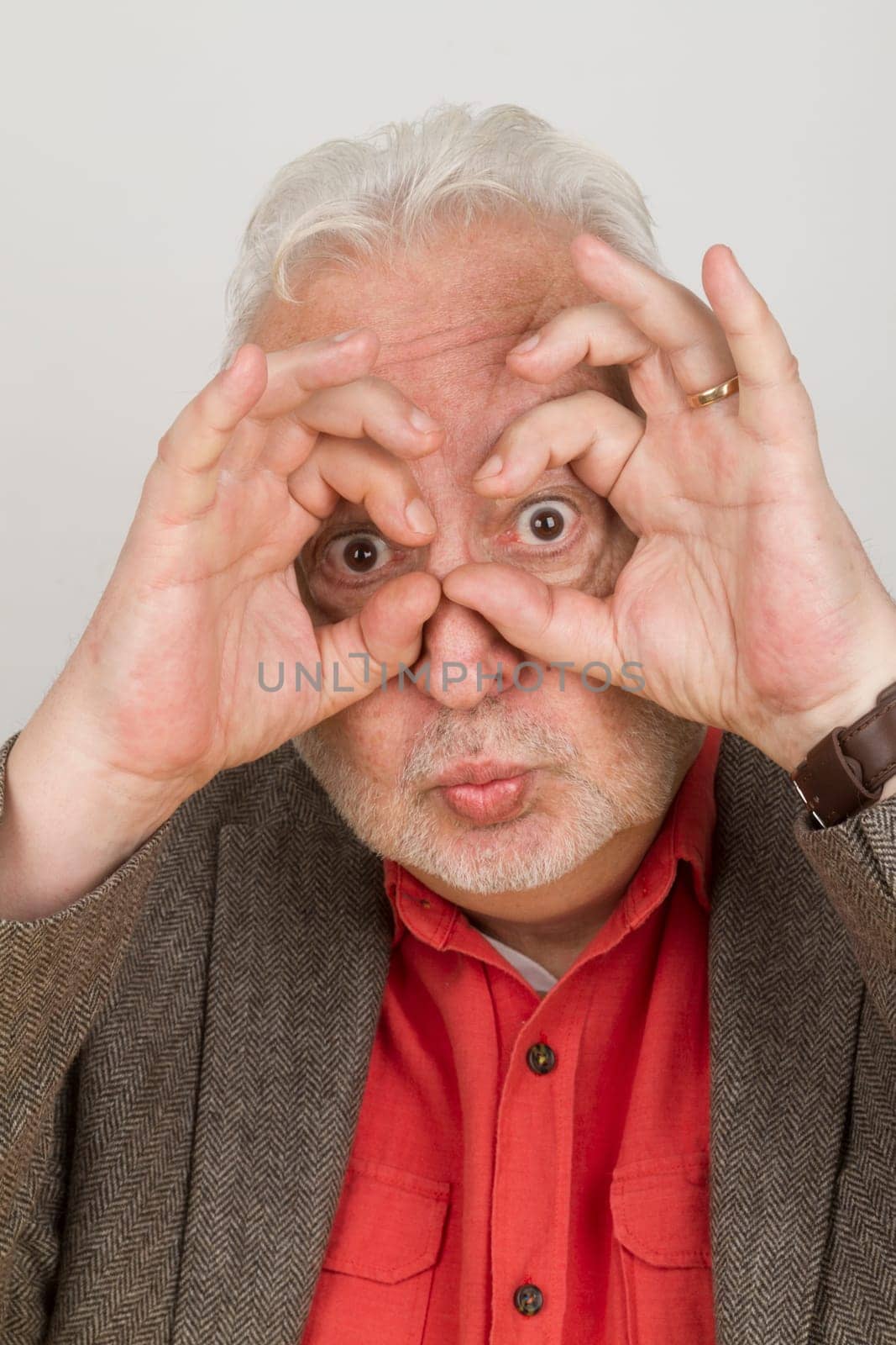 Senior holds fingers around his eyes - symbolism for the future and vision