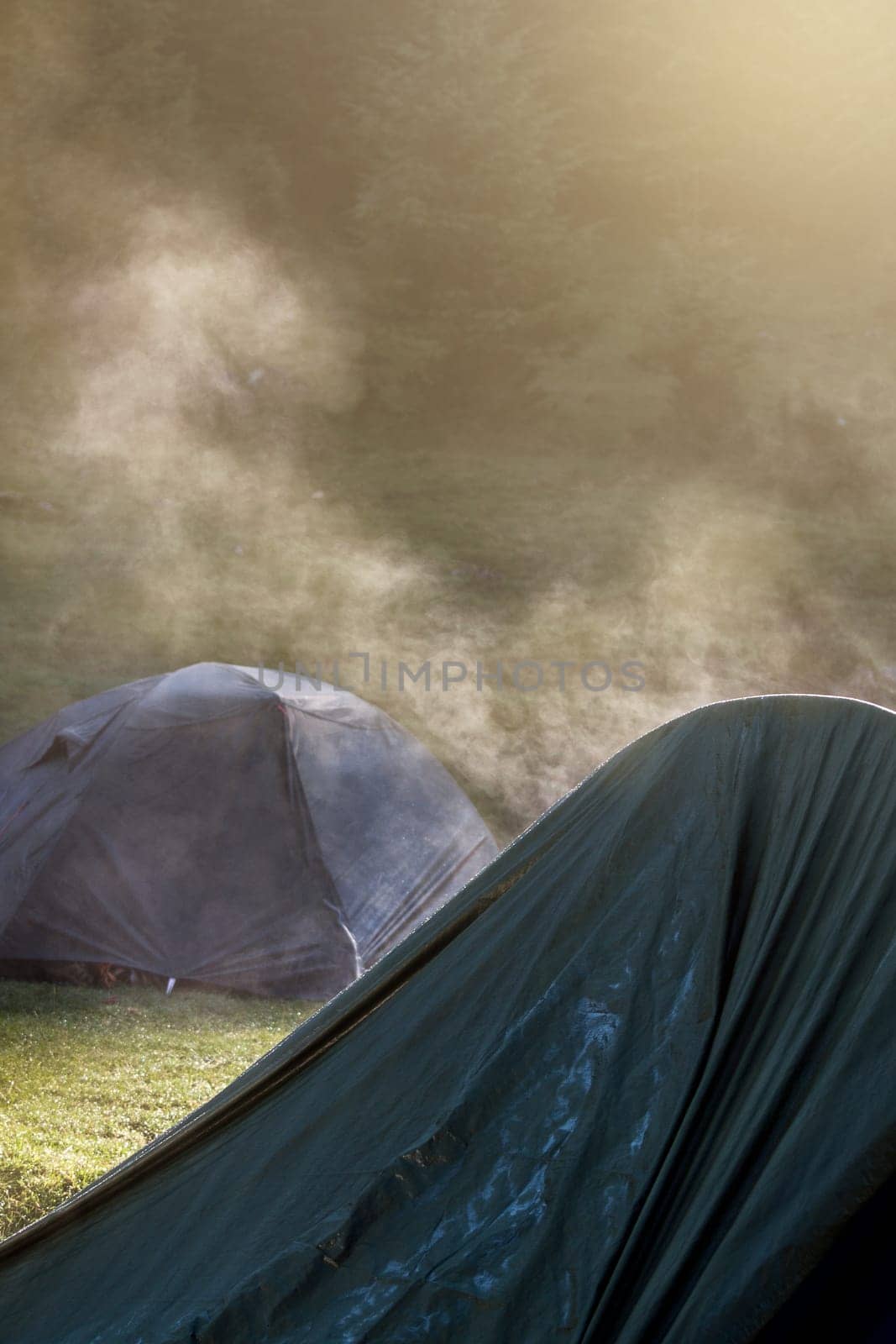 Tents in the morning light with steam coming out of them