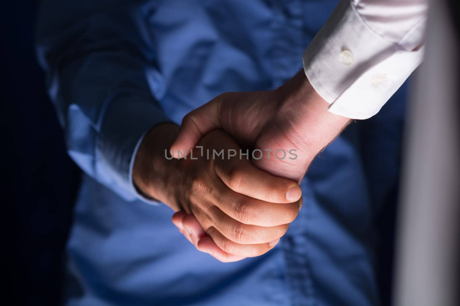 Two Businessman Handshake Handshaking between darkness and light