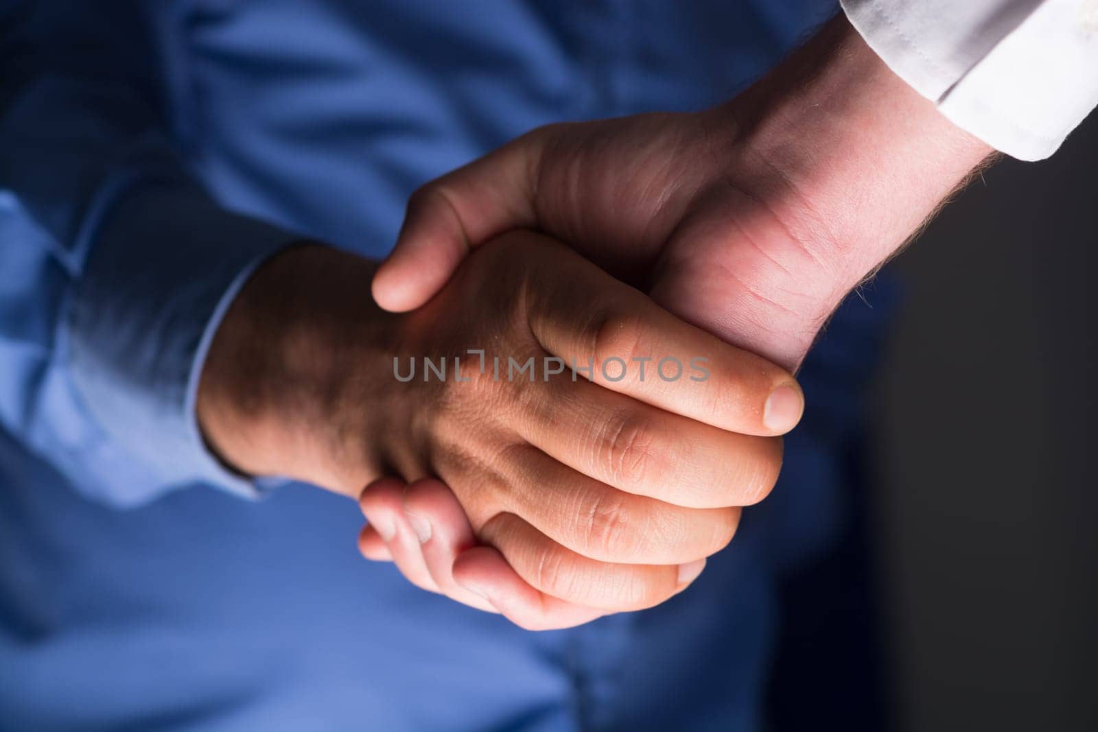 Two Businessman Handshake Handshaking between darkness and light