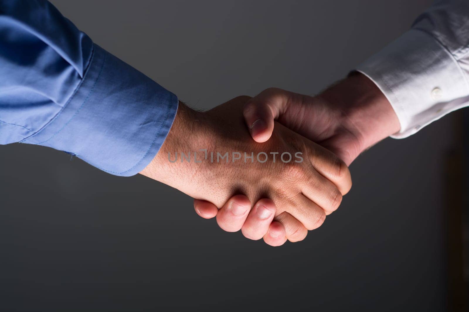 Two Businessman Handshake Handshaking between darkness and light