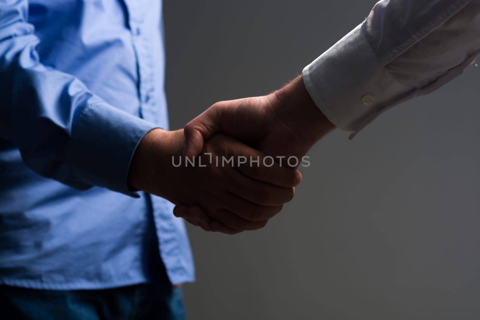 Two Businessman Handshake Handshaking between darkness and light