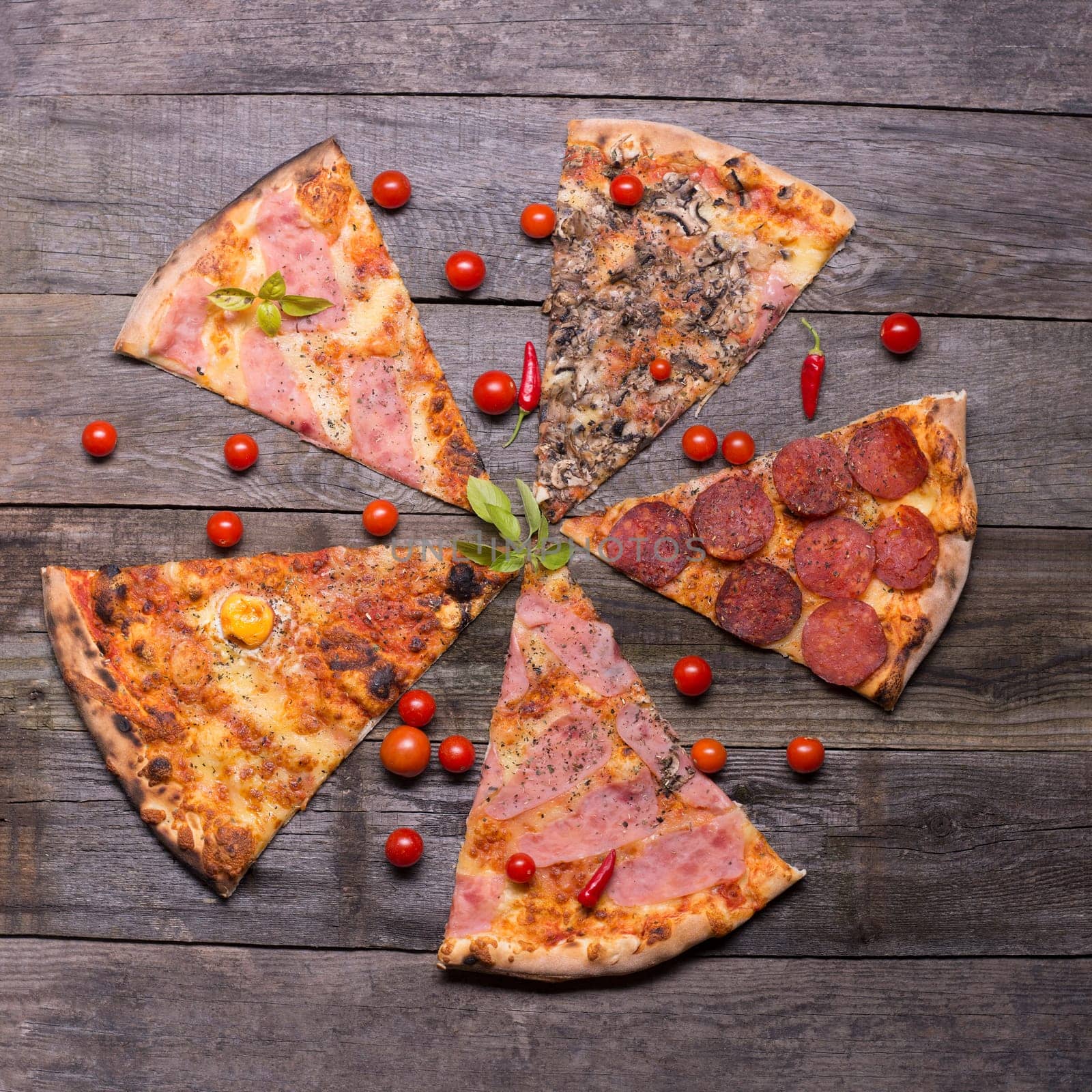 Diferent pizza parts on table, table top view
