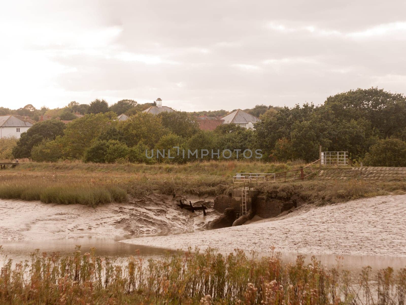 peaceful riverbed coast scene with tide out and low, across the way country horizon  essex  england  uk