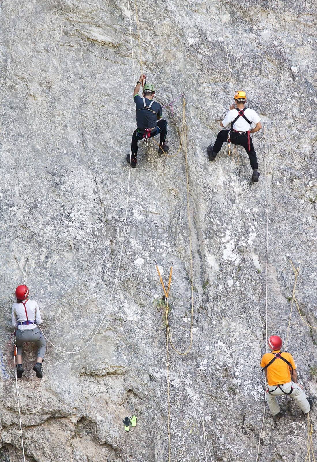 Group of beginner climbers learning to escalate rocks