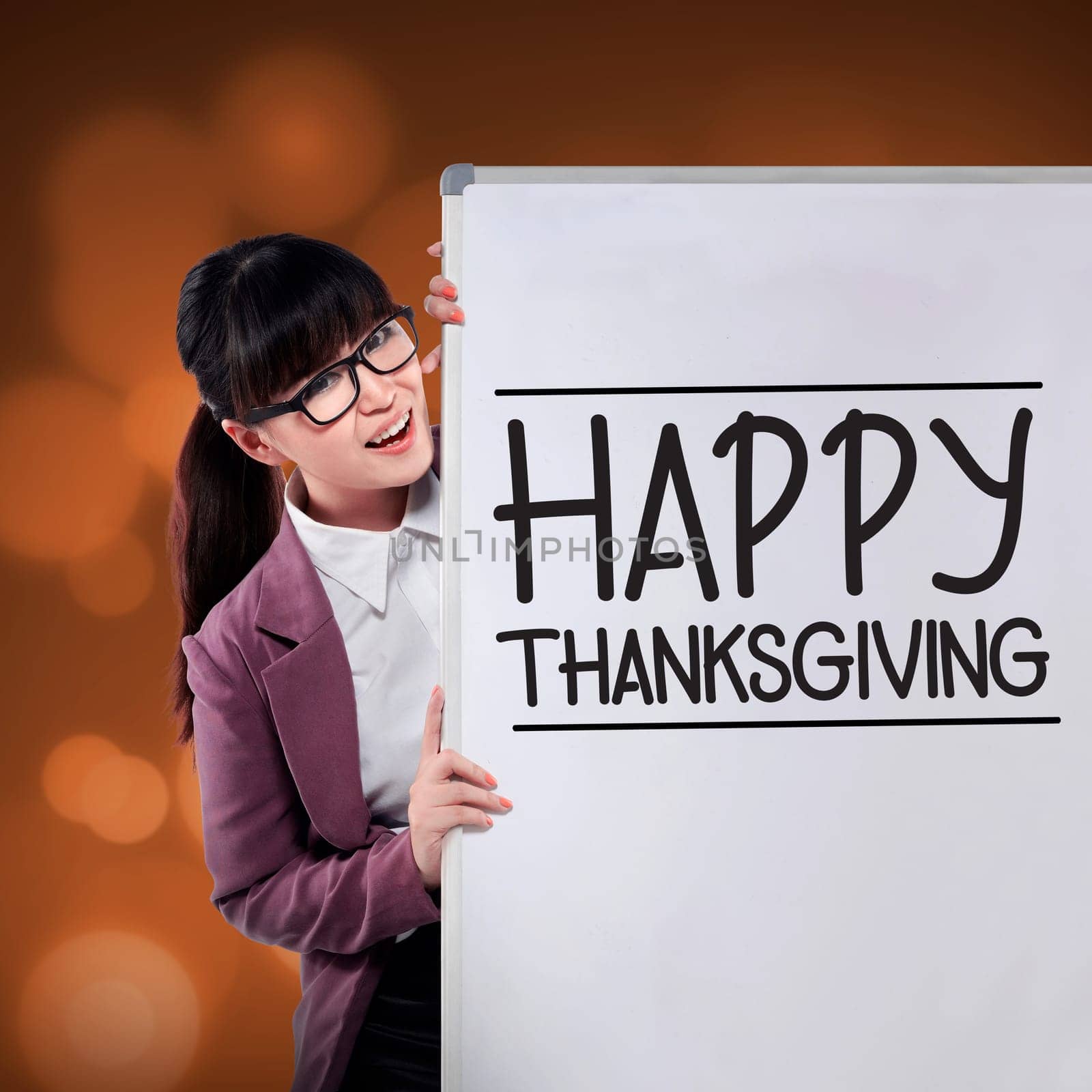 Asian woman smiling show happy thanksgiving writing on the whiteboard