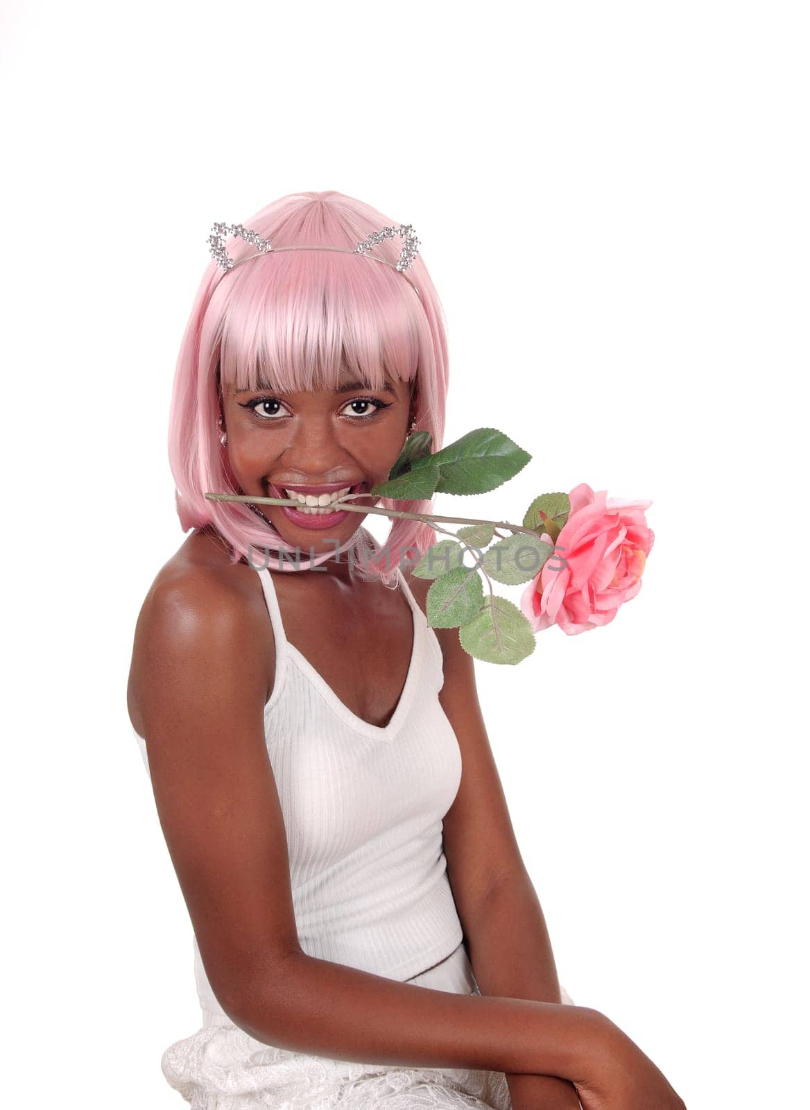 A portrait image of a young African woman with pink hair and a rose.in her mouth, with bunny ears, isolated for white background.