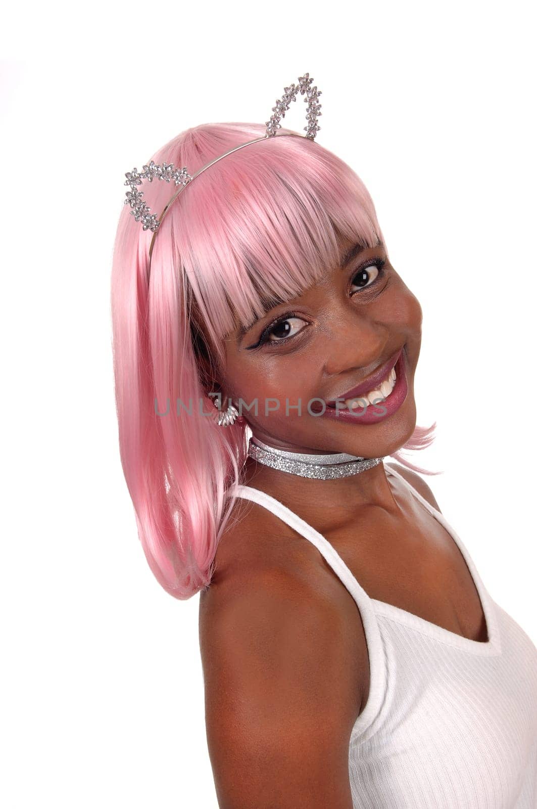 A lovely smiling young African woman with pink hair and silver bunny.ears in a closeup portrait image, isolated for white background.