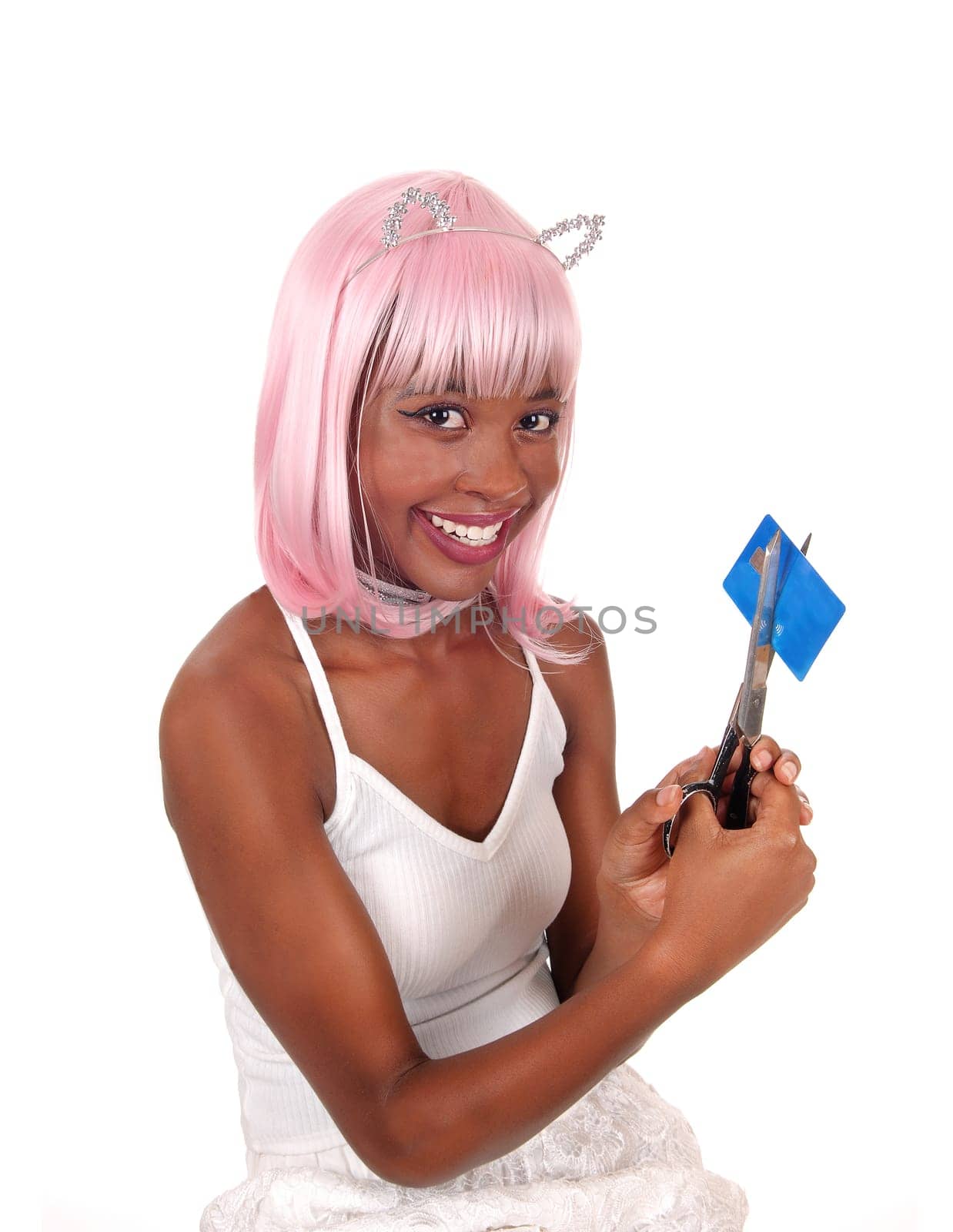 A beautiful young woman with pink hair and bunny ears cutting up.her credit card, smiling and is happy, isolated for white background.
