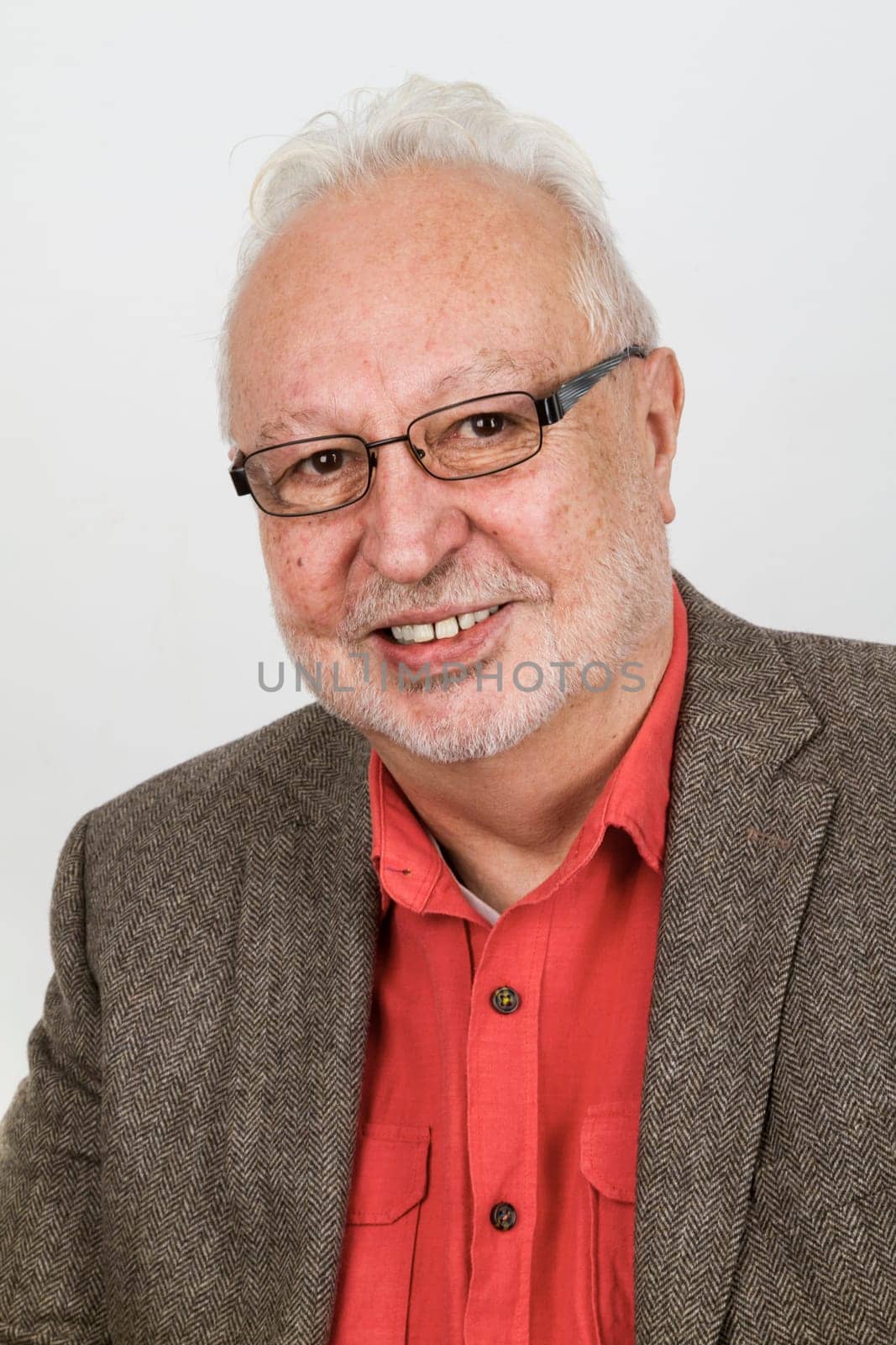 Portrait of friendly laughing senior on a bright background