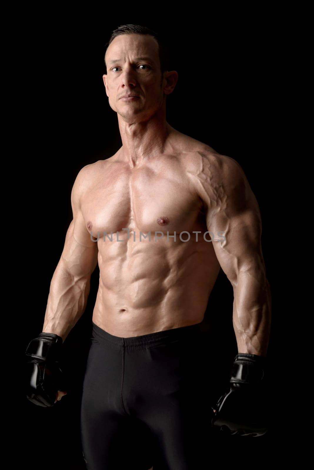 Strong Mixed Martial Arts fighter isolated in black