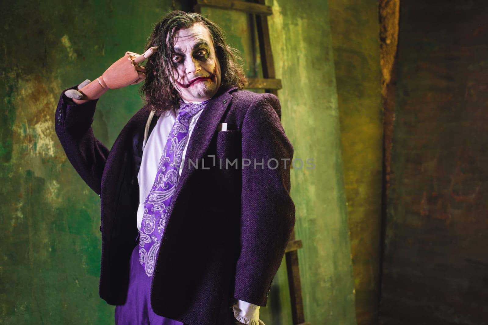 Bloody Halloween theme: The crazy maniak face on dark studio background