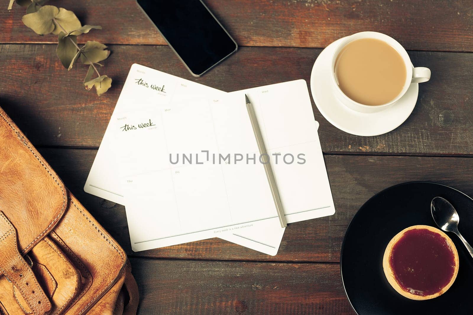 Opened craft paper envelope , autumn leaves and coffee on rustic wooden table
