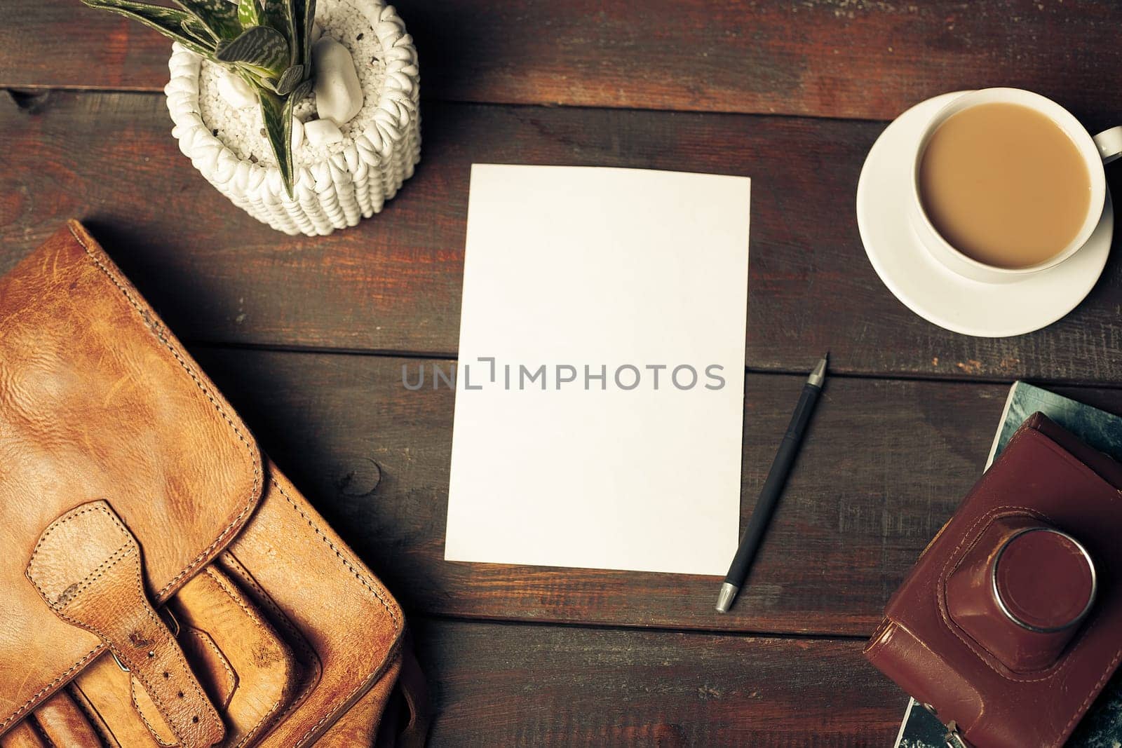 Opened craft paper envelope , autumn leaves and coffee on rustic wooden table