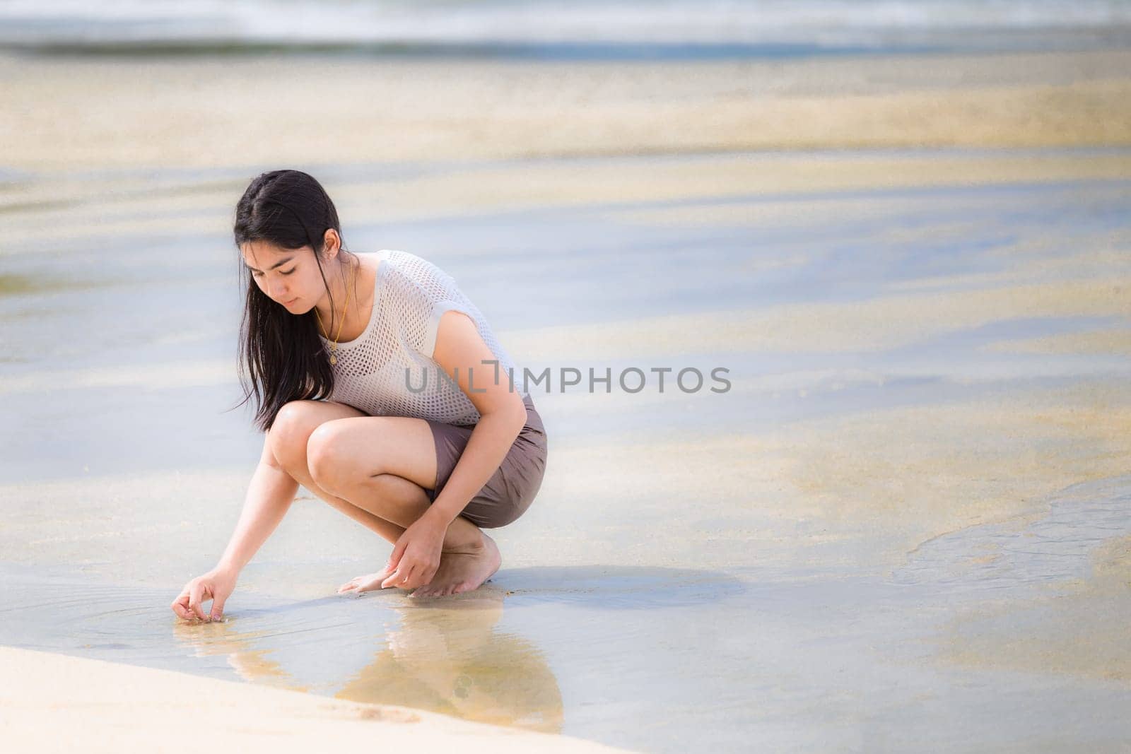 Beautiful Asian woman vacation on beach of Thailand.