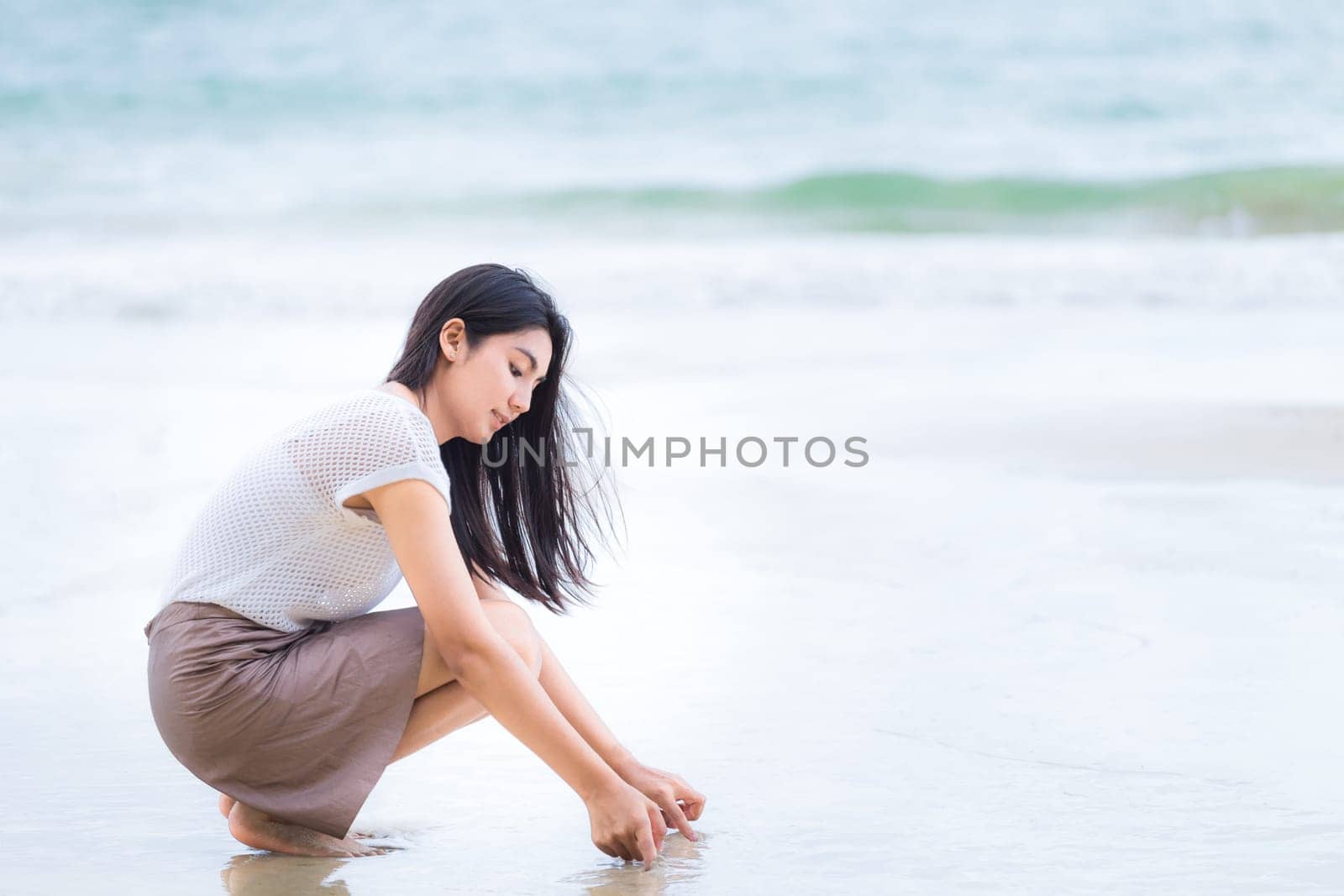 Beautiful Asian woman vacation on beach of Thailand.