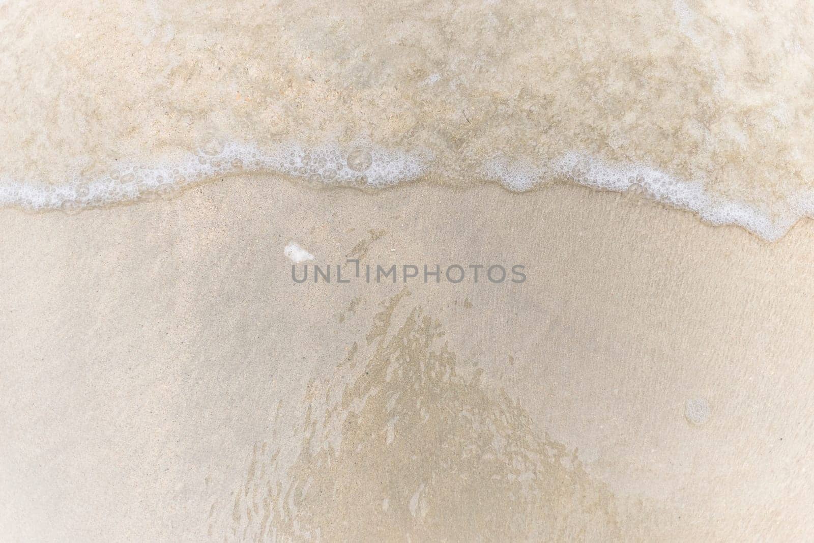 Closeup of sand pattern of a beach in the summer