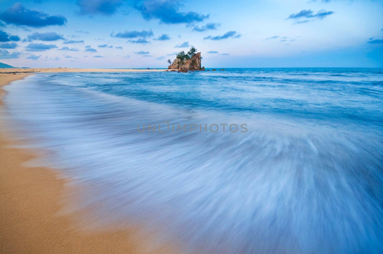 Long exposure slow shutter of waves during sunset at Kemasik beach, Terengganu, Malaysia