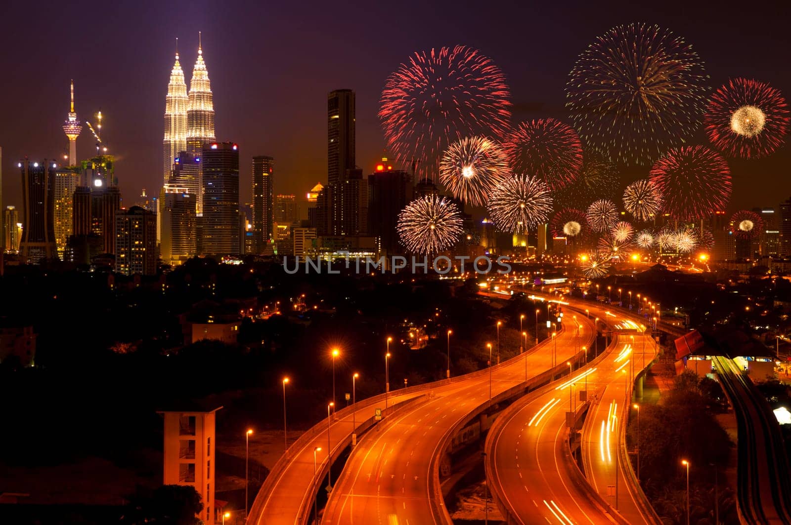 The capital of Malaysia, Kuala Lumpur city skyline night view with fireworks over the sky.