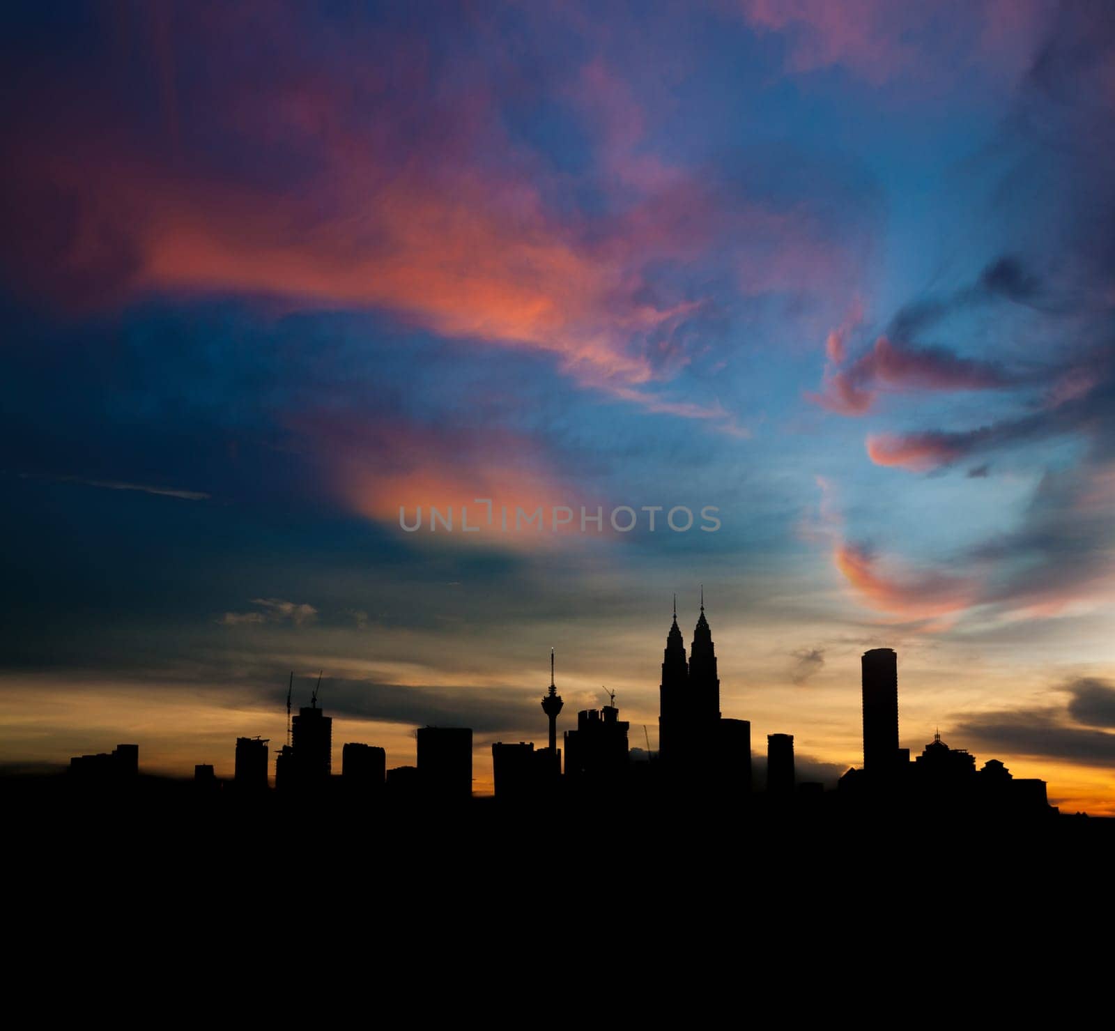 Silhouette Kuala Lumpur city skyline in twilight.