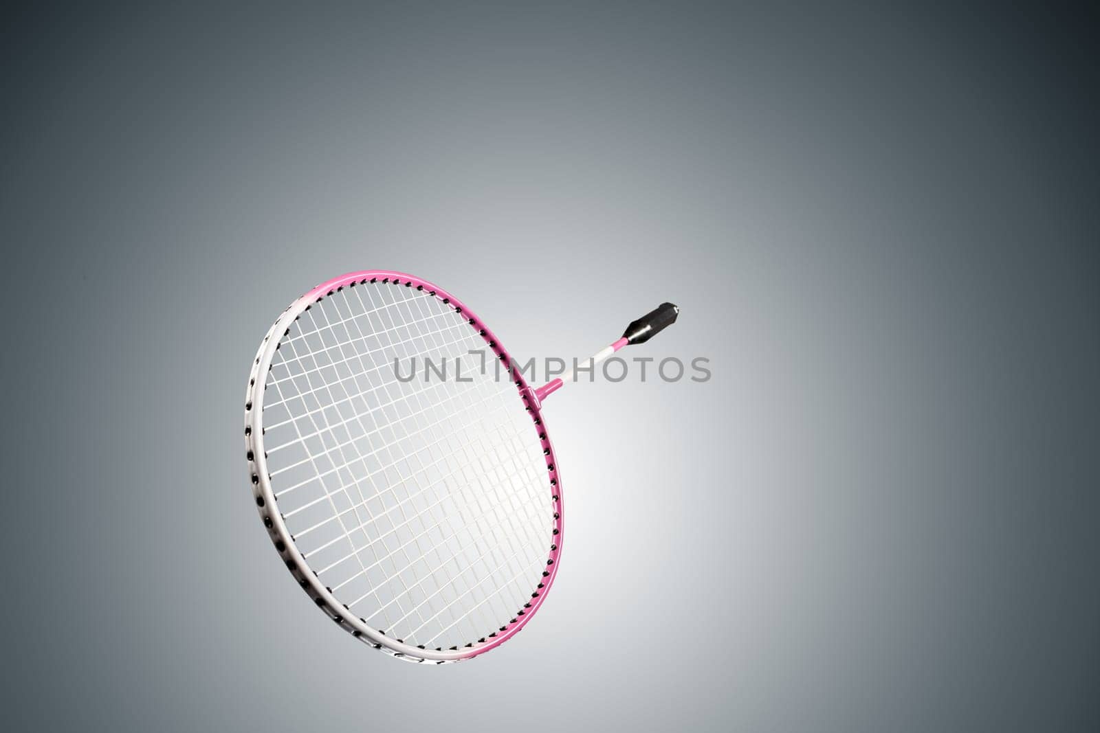 Color photo of one racket for badminton isolated on gray