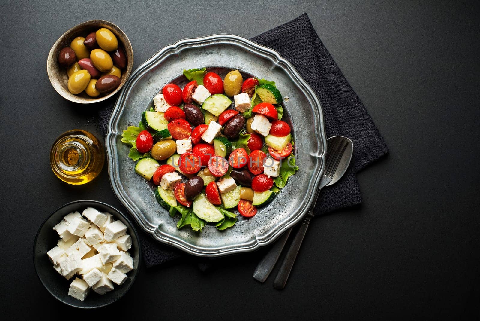Salad with cheese and fresh vegetables on black background. Greek salad.