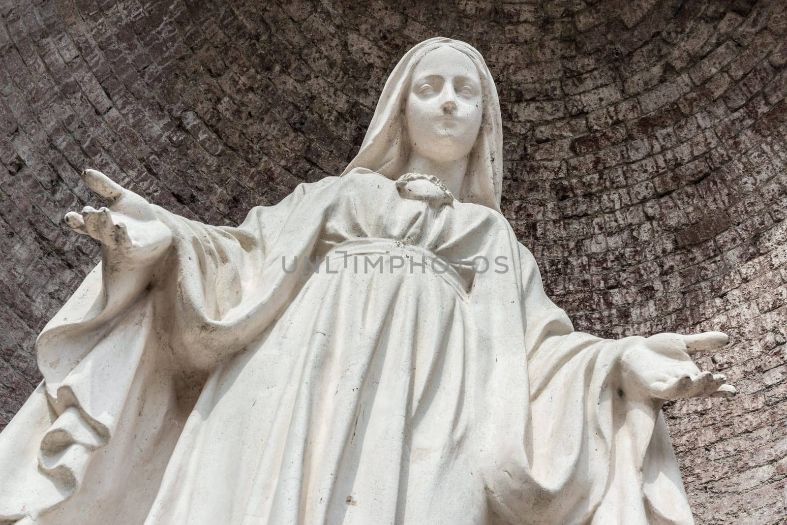 Close-up of Our Lady with open arms, bottom view.