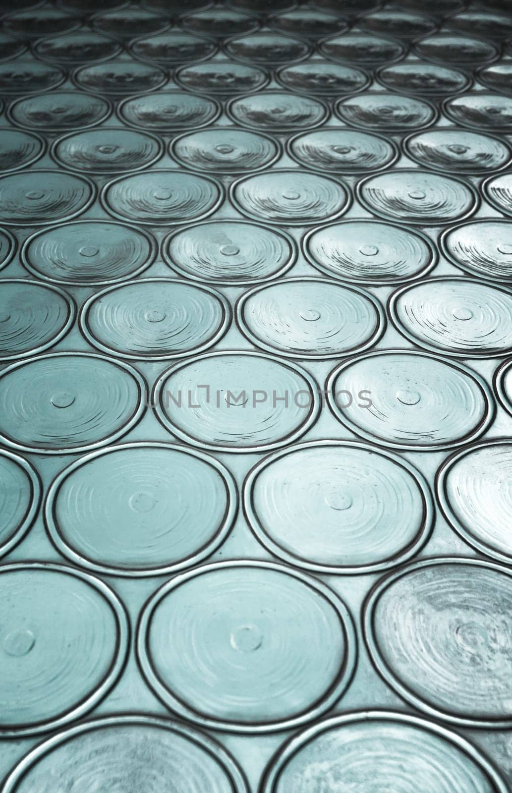 Green window with circular panes of swirled glass. Shallow depth of field.