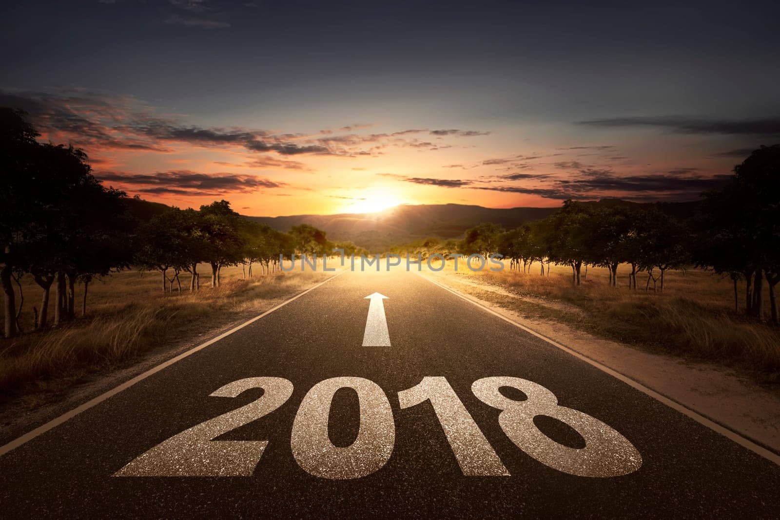 Empty street with arrow and 2018 number over sunset background