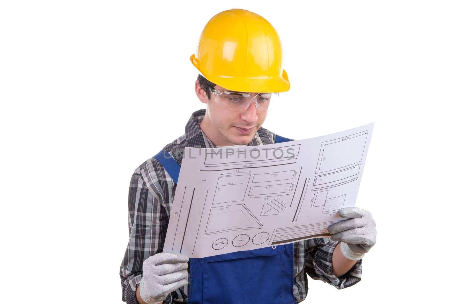 young worker reads a plan on the white background