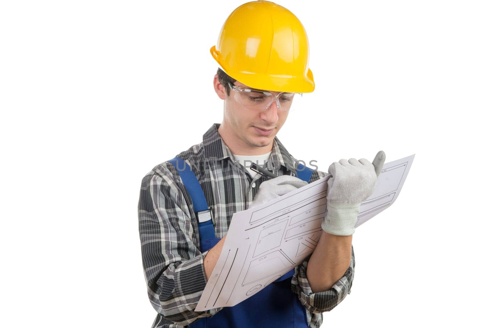 young worker reads a plan on the white background