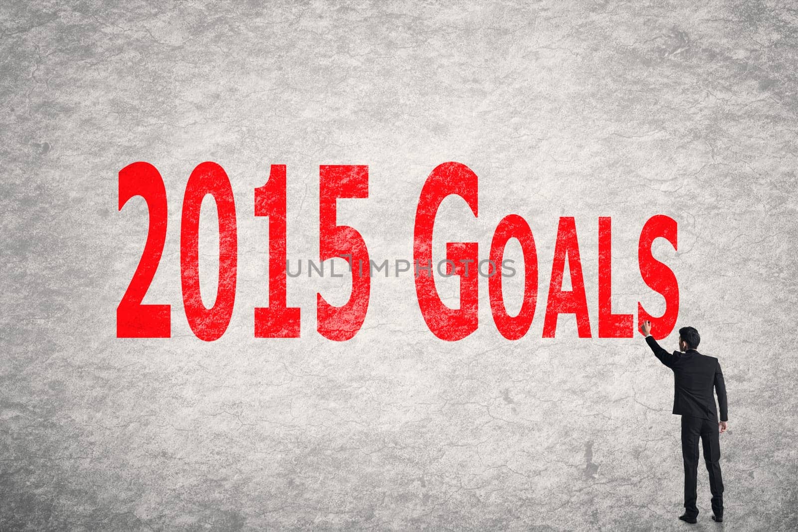 Asian business man write words on wall, 2015 Goals