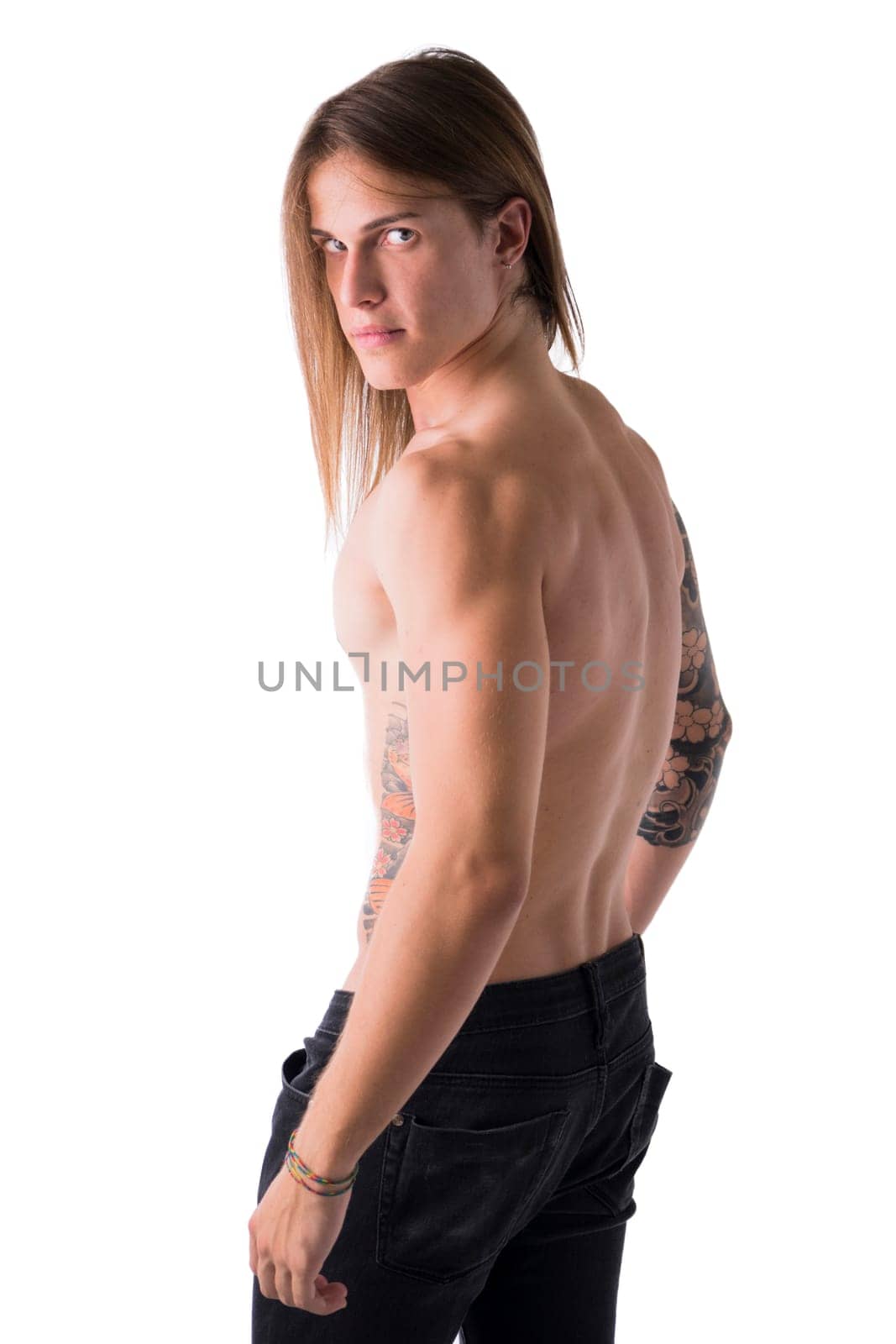 Beautiful young long haired man shirtless, serious, posing isolated on white, profile shot
