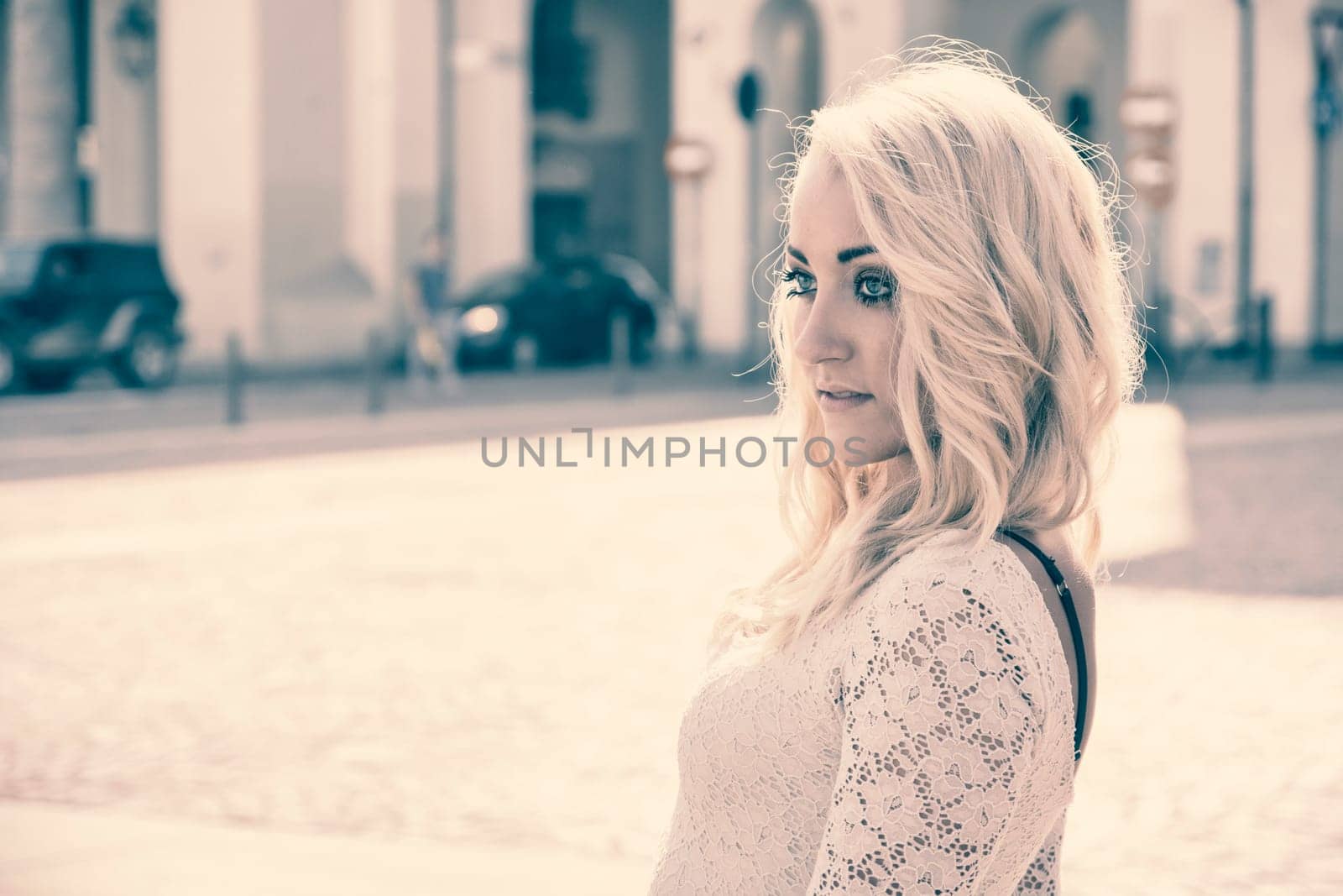 Pretty Young Blonde Woman in Sexy White Dress in Turin City Center, Italy. Captured with Buildings at the Back.