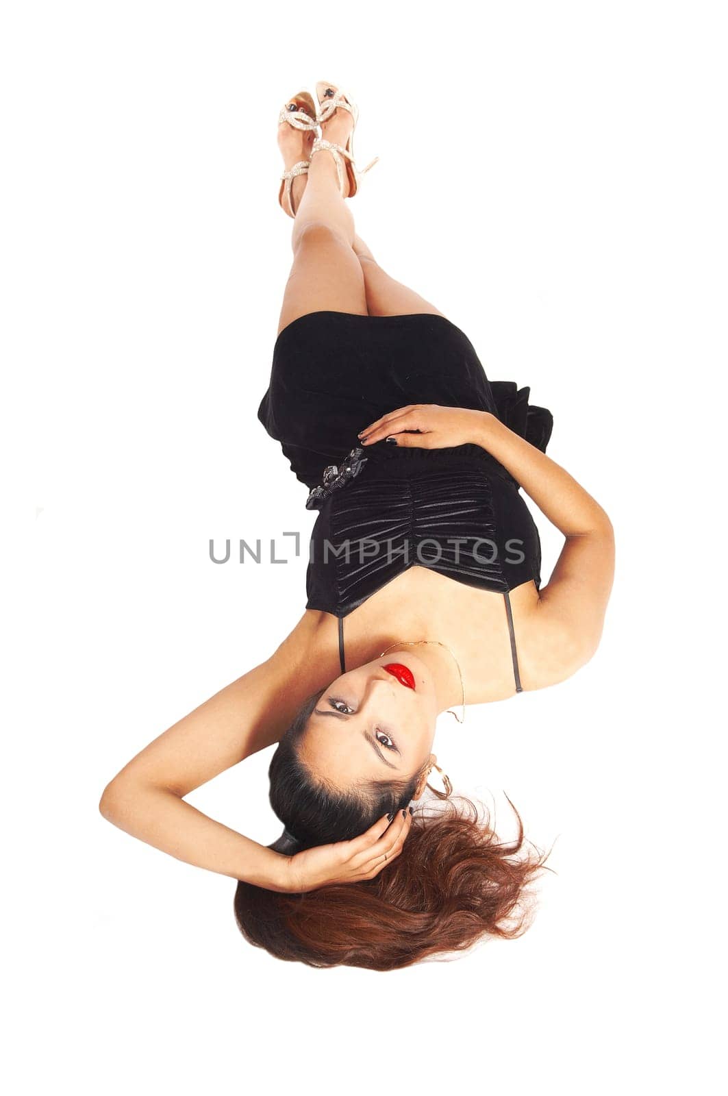 A beautiful woman in a black dress lying upside-down on the floor,.isolated for white background.