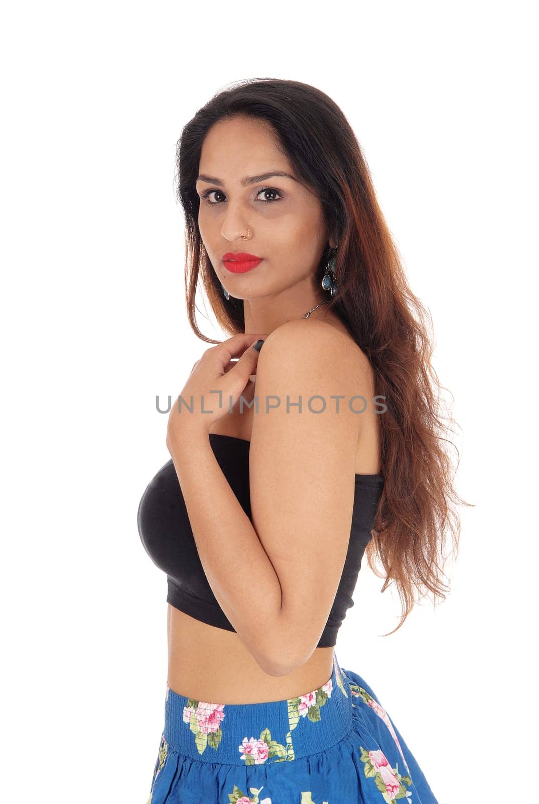 A lovely young slim woman standing in profile, looking at the.camera, isolated for white background.