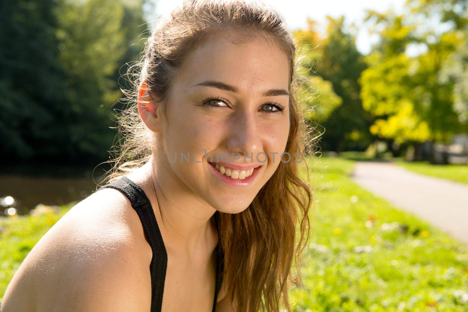 Portrait of young smiling  sporty woman, outdoors