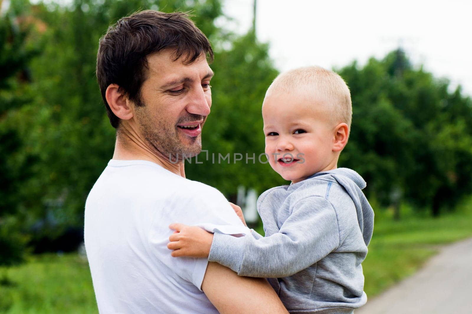 Happy family, uncle and boy on green background.