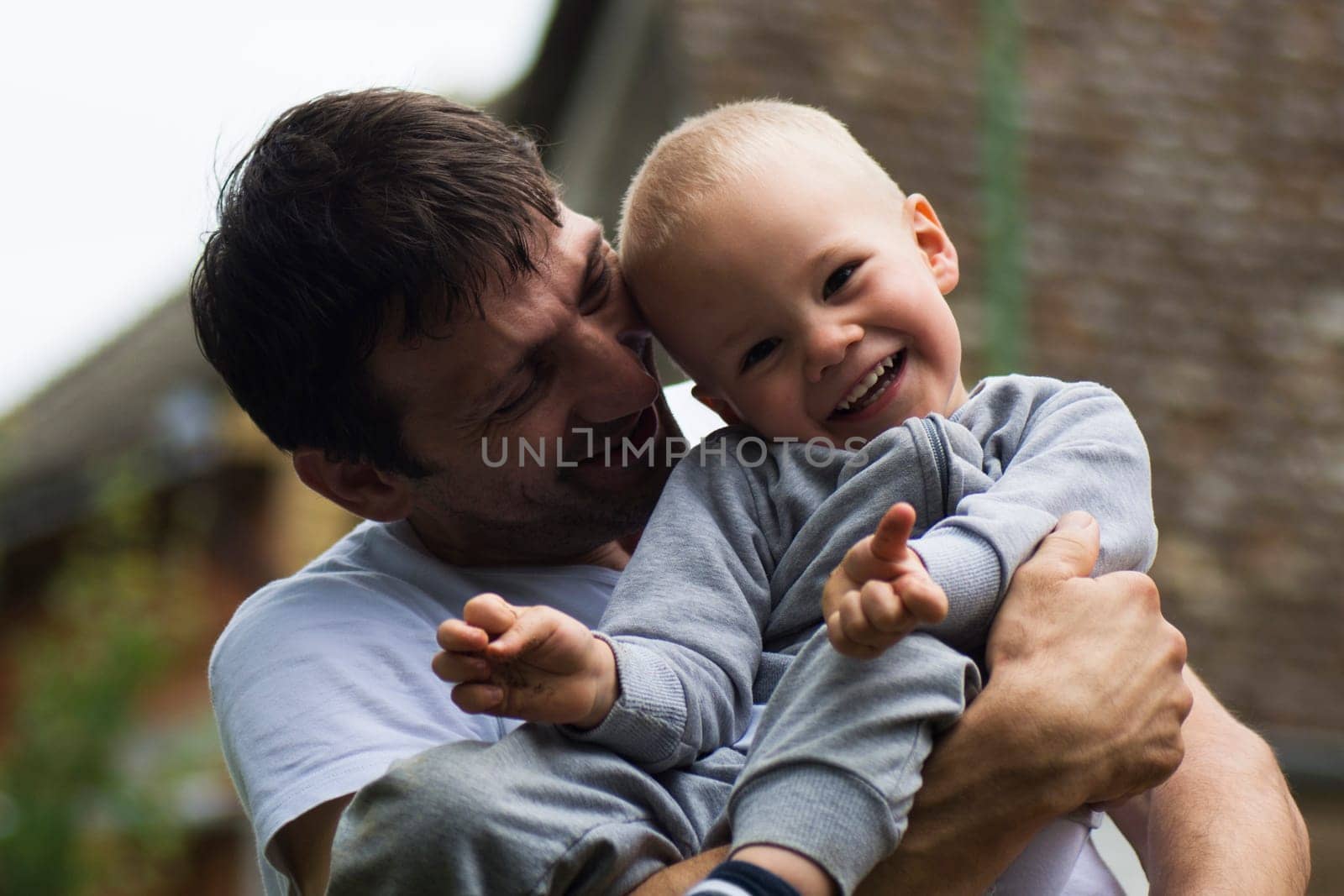Boy and his uncle are laughing and enjoying together.