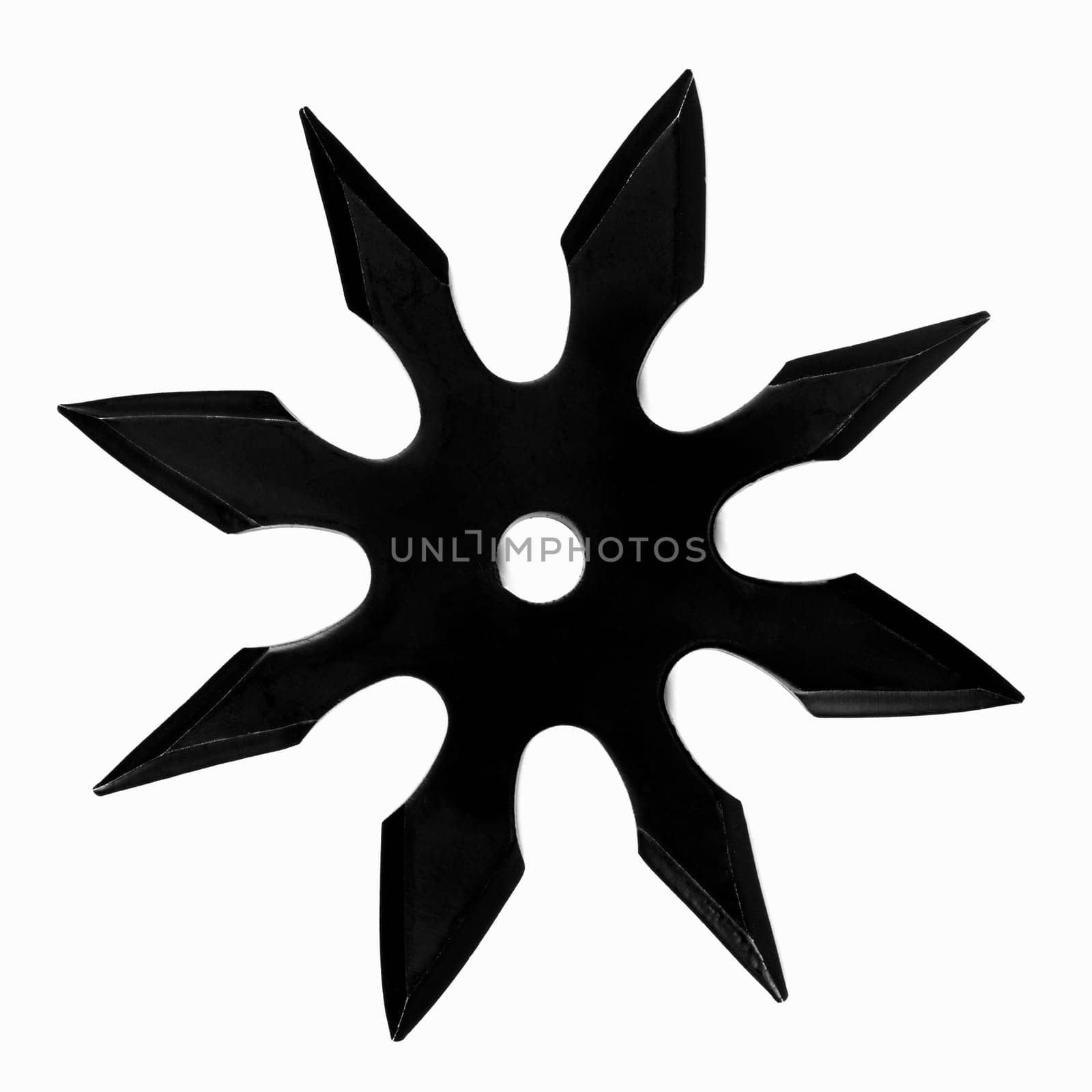 Shuriken from black metal is on white background.