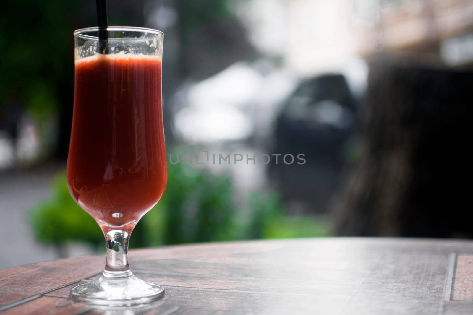 Smoothie from red fruits on the table.